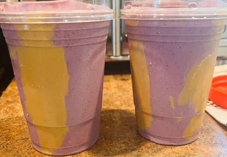Colorful smoothie cups with layered fruit flavors