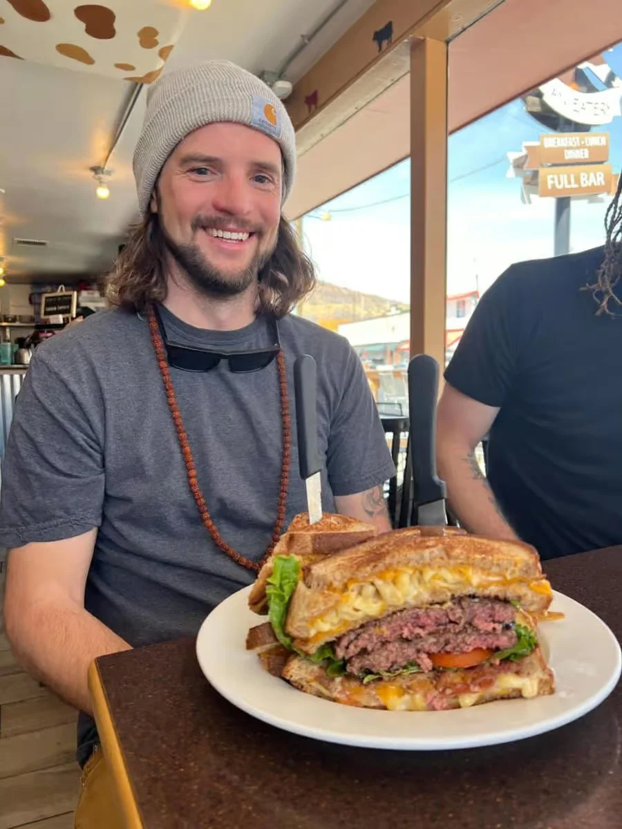 Giant grilled cheese burger sandwich in a cozy diner