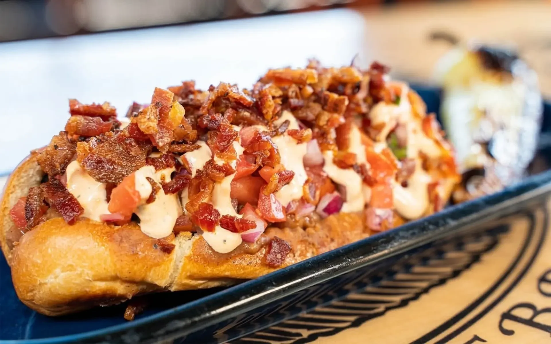 Loaded bacon hot dog with toppings