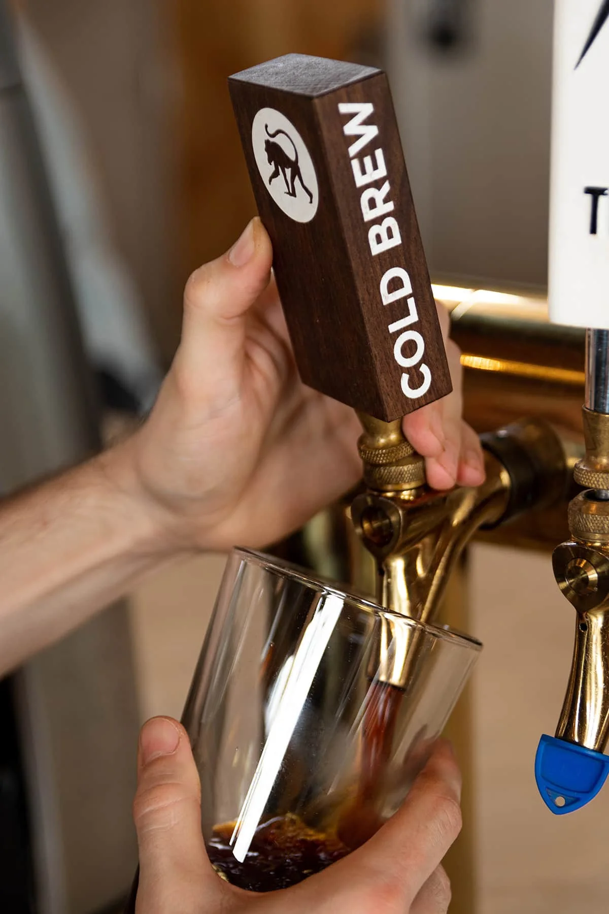 Pouring cold brew coffee from a tap