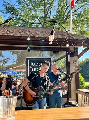 Guitarist playing on the Sunset Grill patio stage