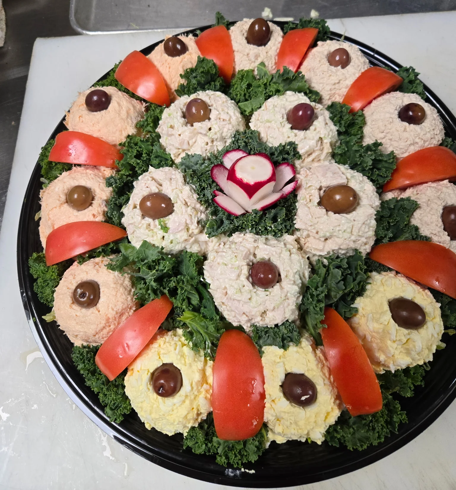 Colorful Russian salad platter with decorative garnishes