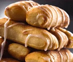 Cinnamon rolls drizzled with icing stacked high