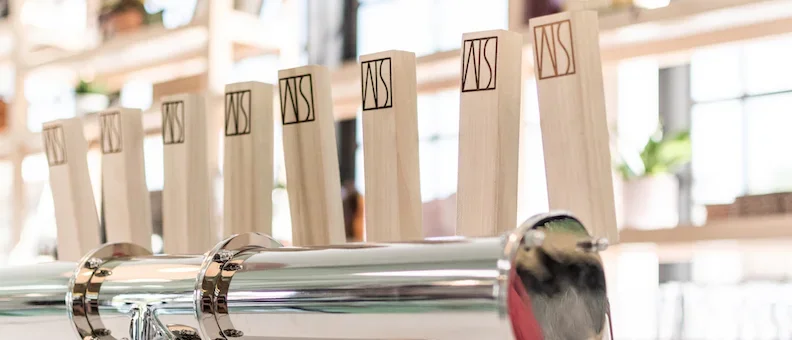 Craft beer taps with wooden handles at a modern bar