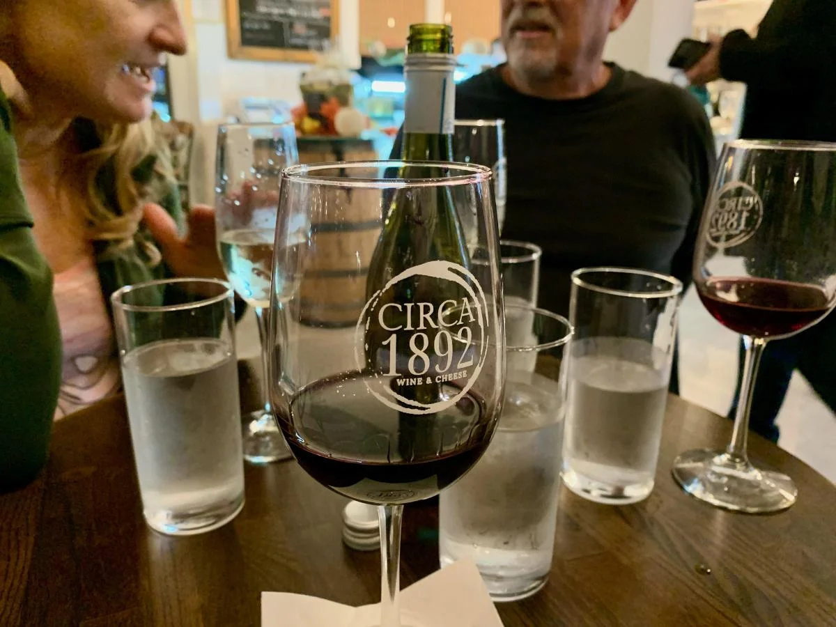Wine glass with red wine at a cozy restaurant table