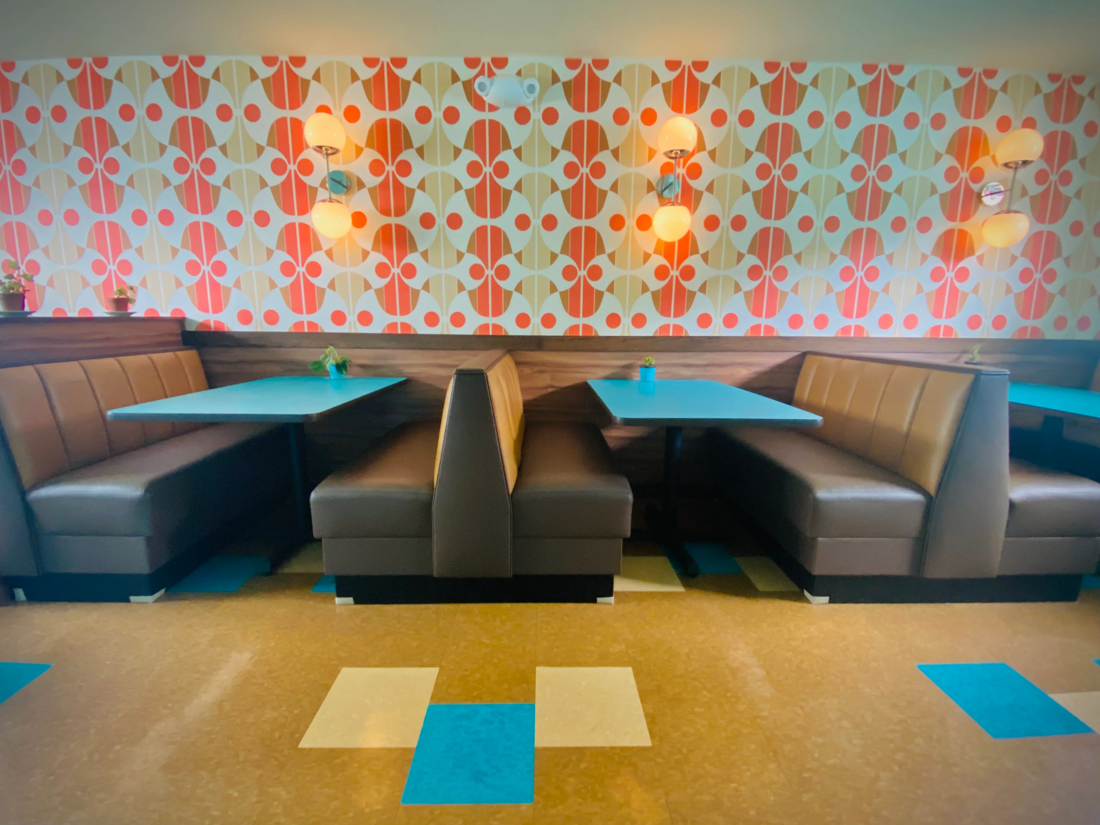 Stylish restaurant interior with retro decor and cozy seating booths