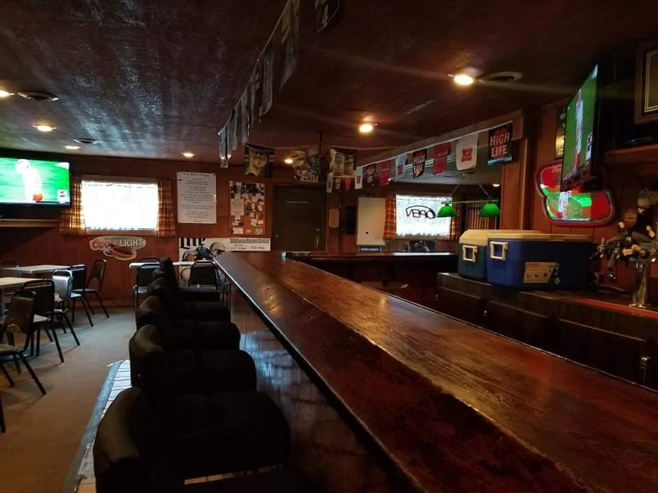 Cozy bar interior with wooden counter and seating