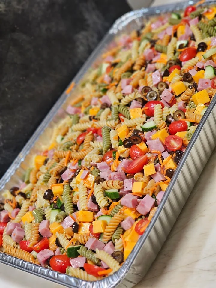 Colorful pasta salad in a large serving tray