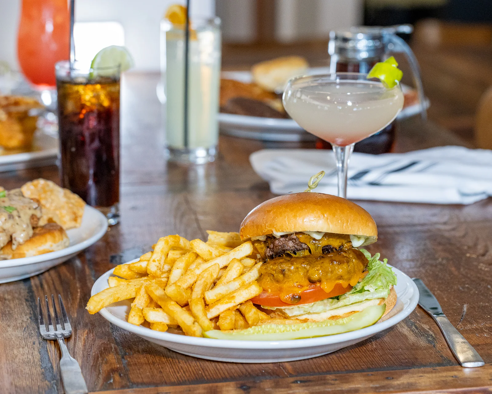 Juicy cheeseburger with fries in a casual dining setting