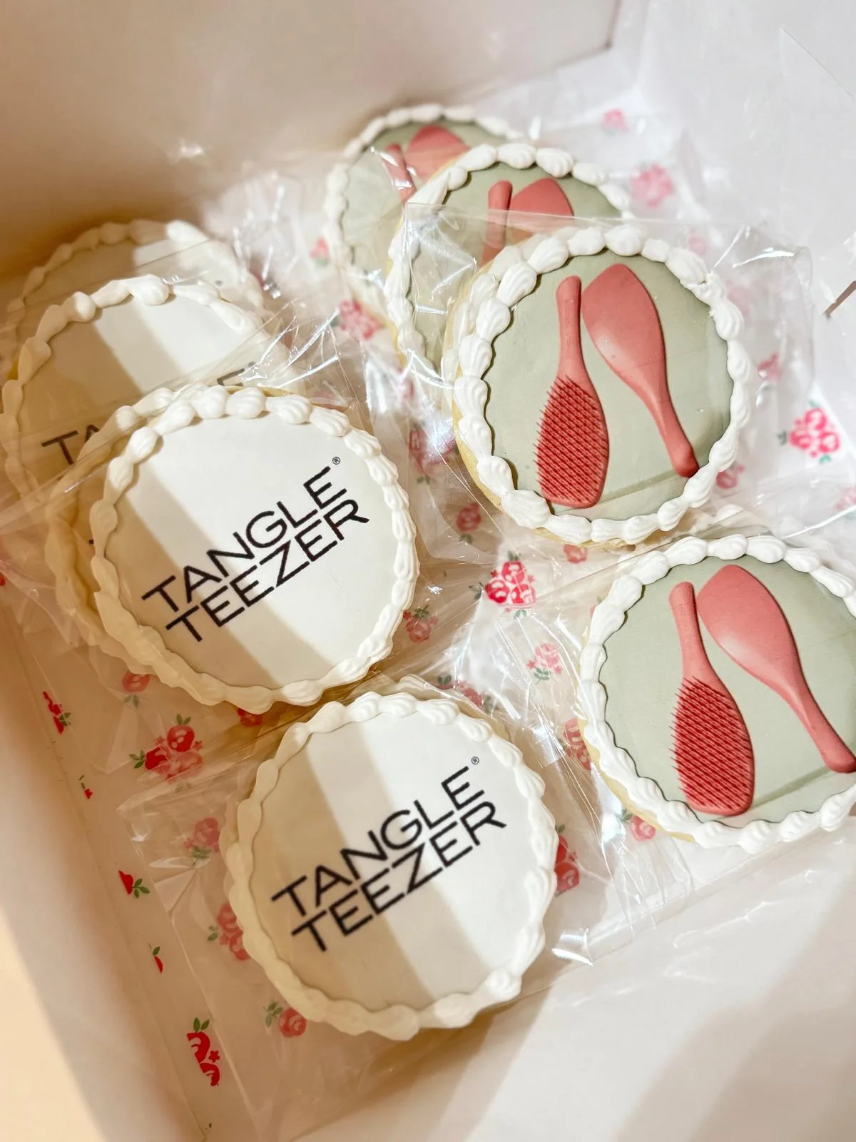 Decorative cookies featuring Tangle Teezer branding and hairbrush designs