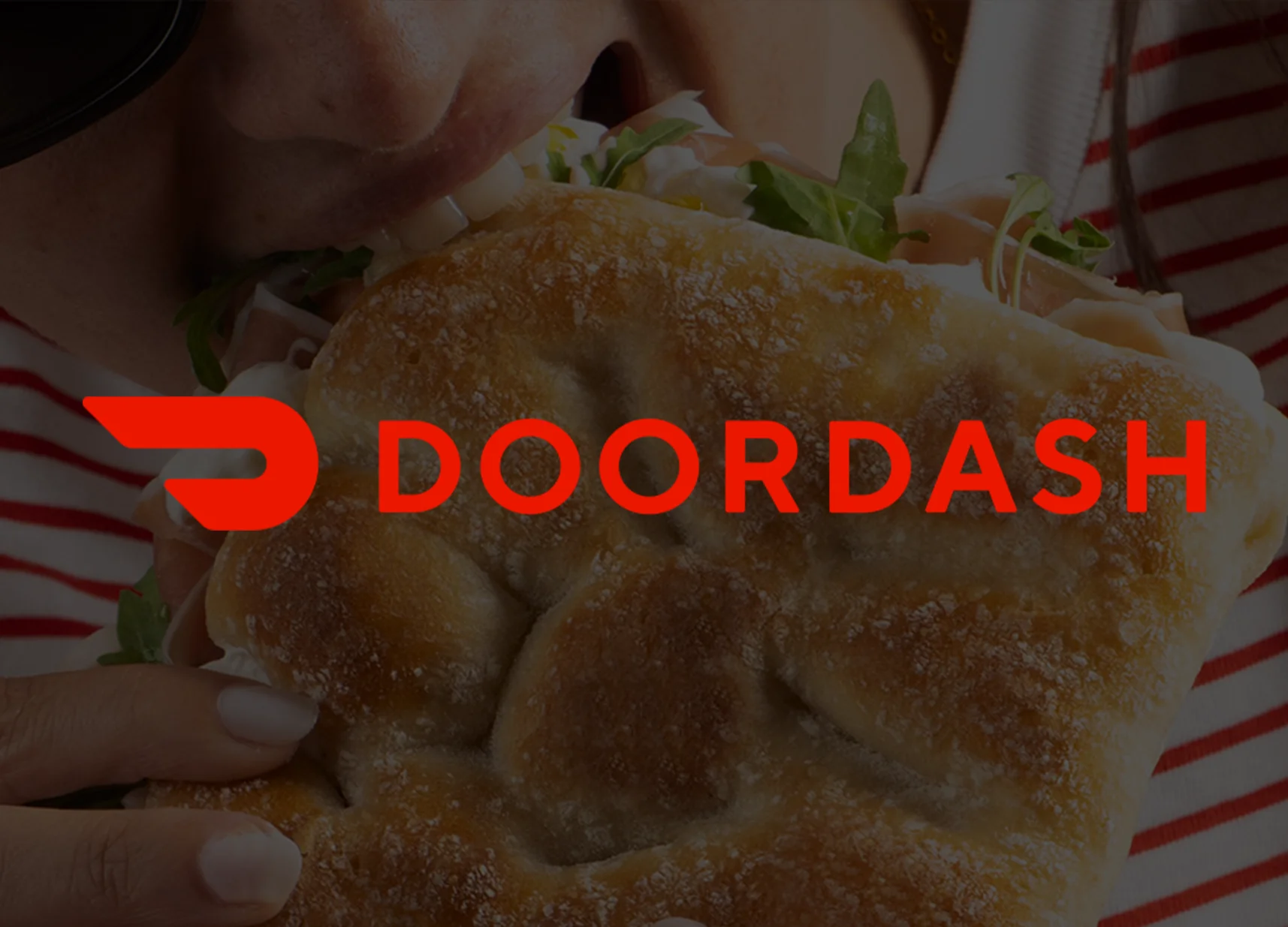 Person enjoying a fresh sandwich from DoorDash