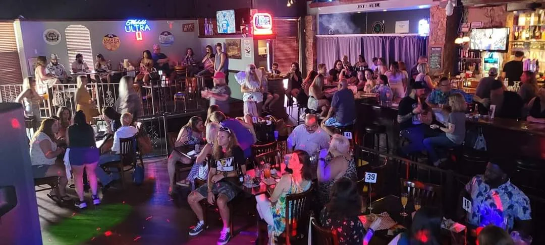 Lively bar scene with patrons enjoying drinks and entertainment