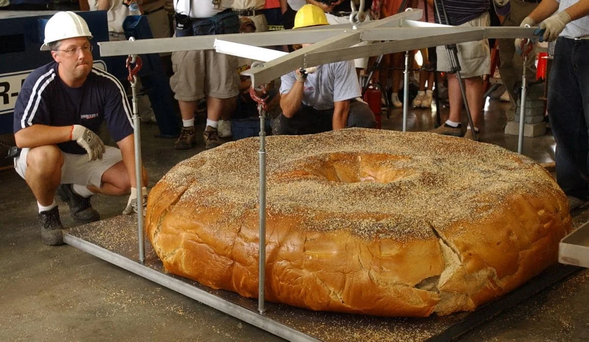 Giant bagel being lifted at a food festival