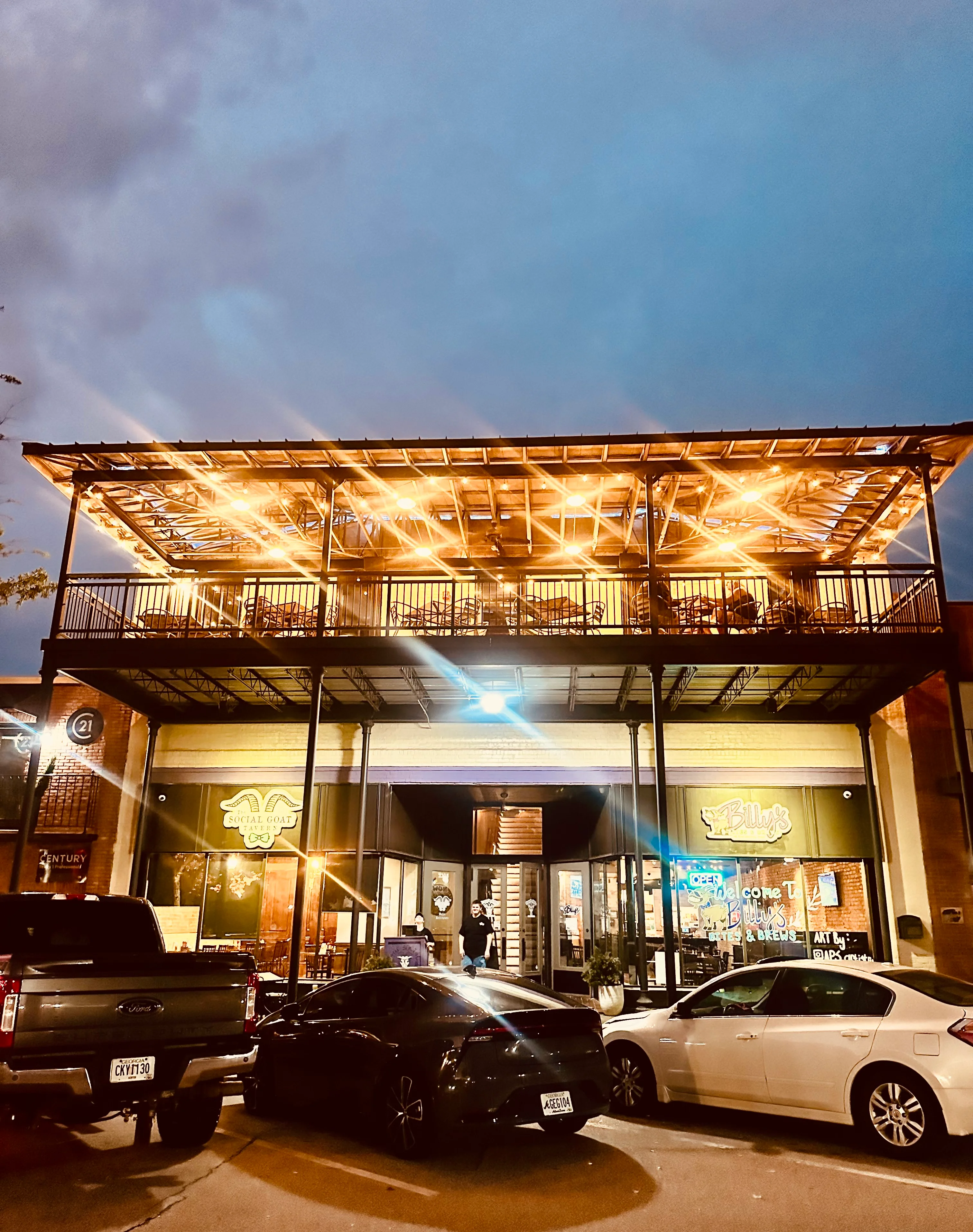 Charming restaurant exterior illuminated at night with string lights