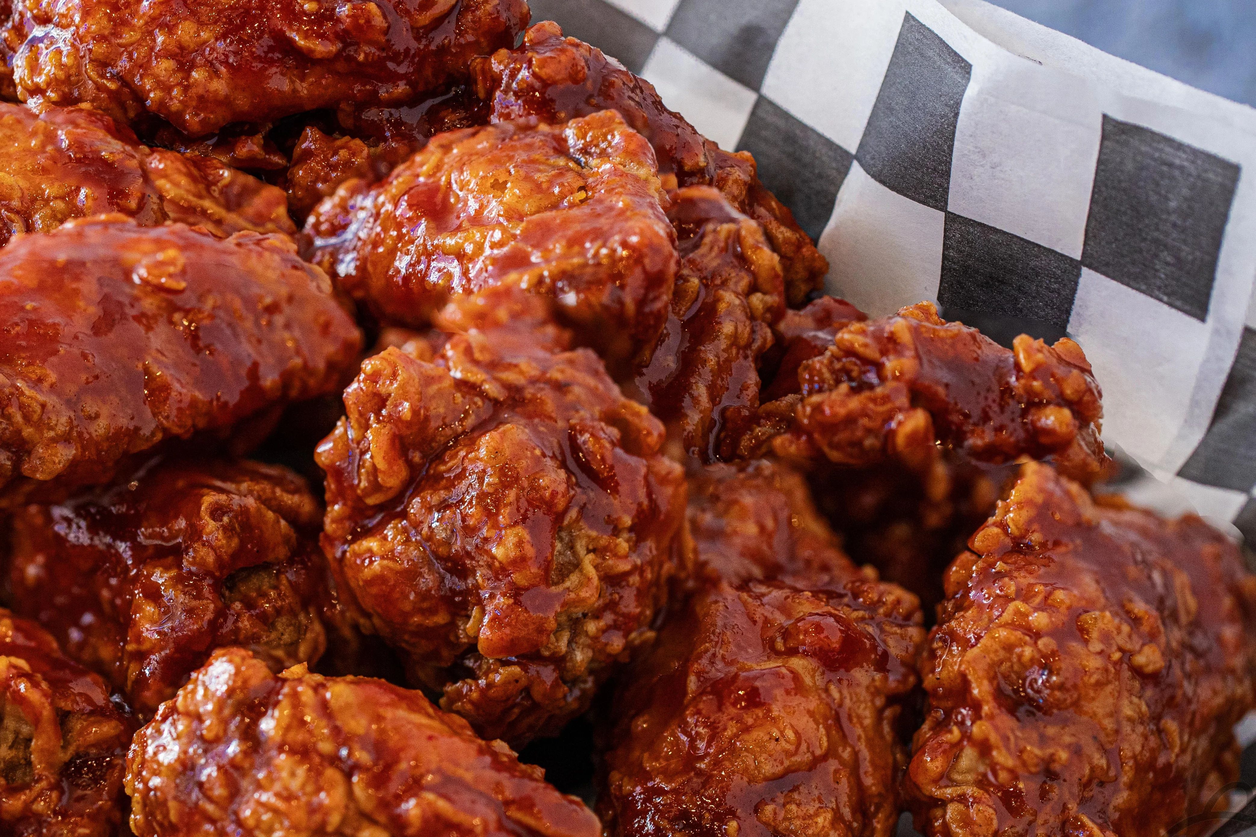Crispy buffalo chicken wings served in a checkered basket