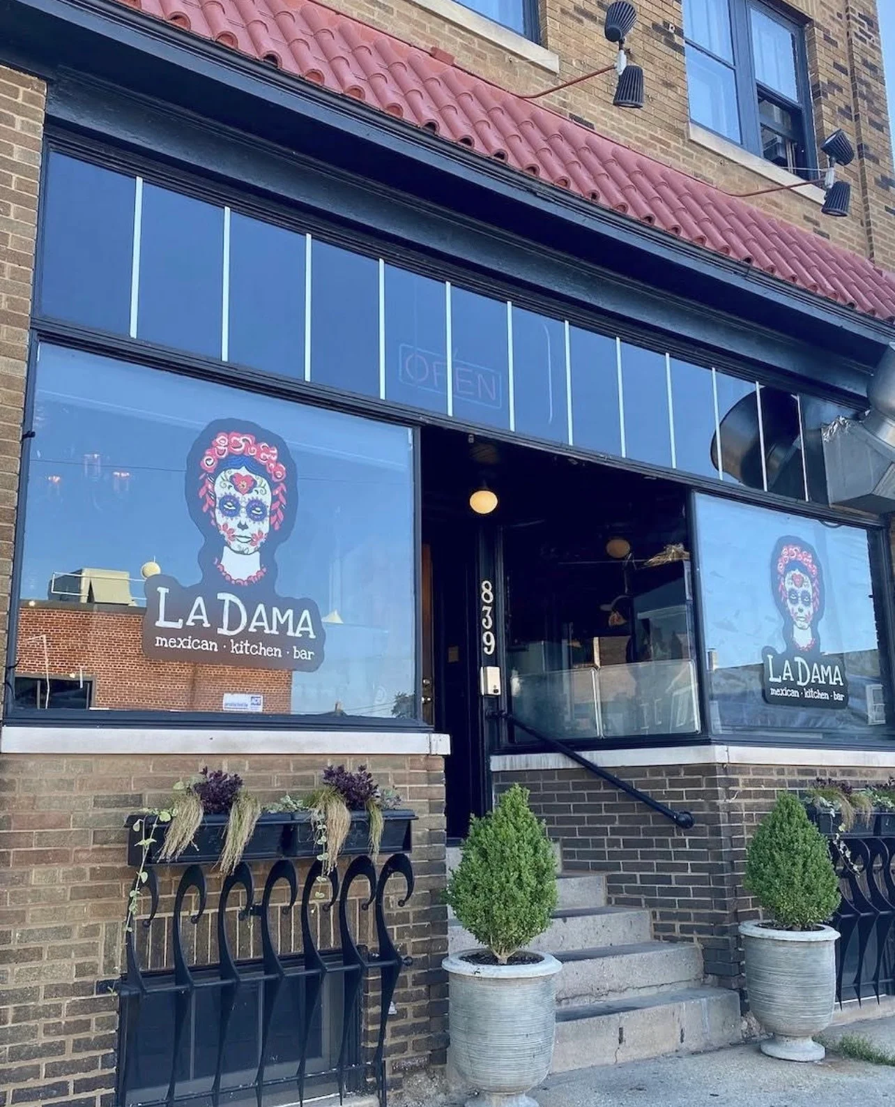 Exterior view of La Dama Mexican kitchen and bar with vibrant signage