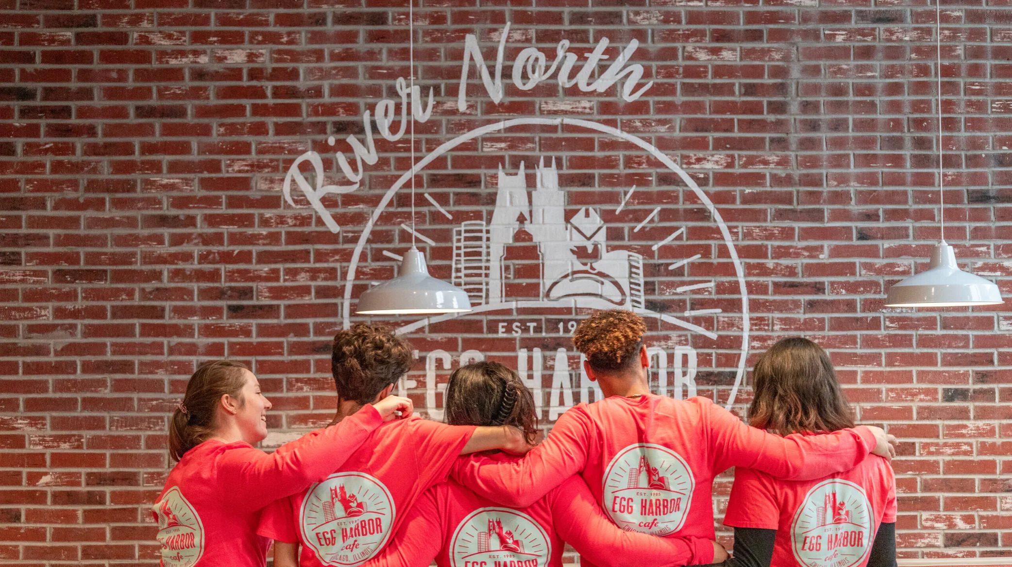 Team members in red shirts at Egg Harbor Cafe's River North location