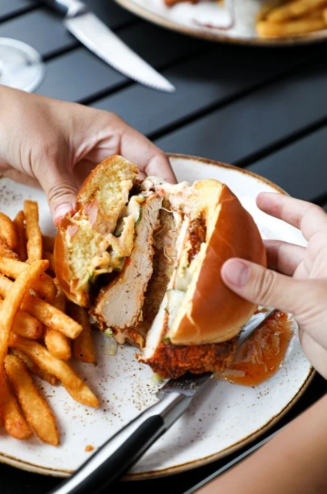 Delicious chicken sandwich with lettuce and sauce on a toasted bun