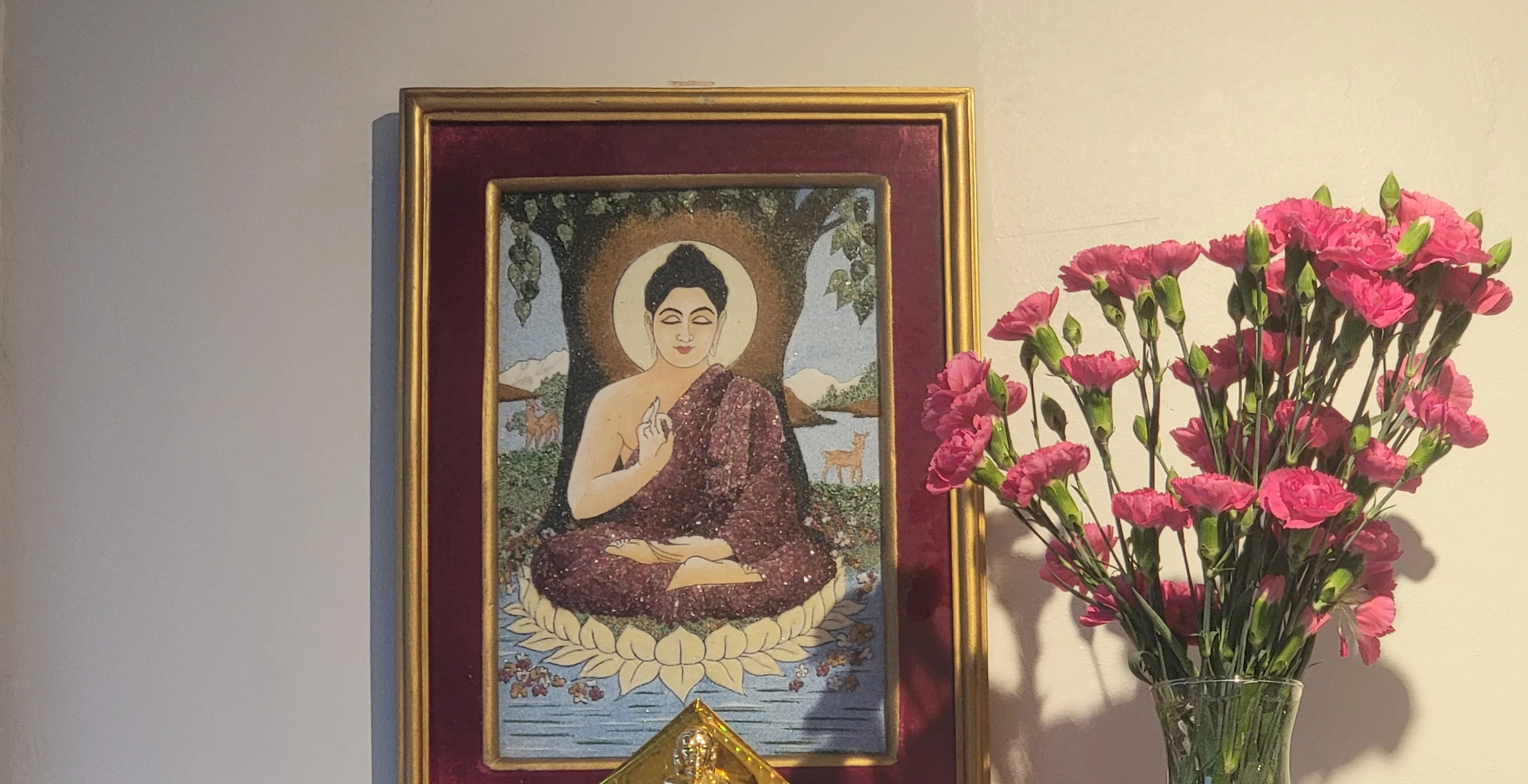 Buddhist altar with flowers and artwork
