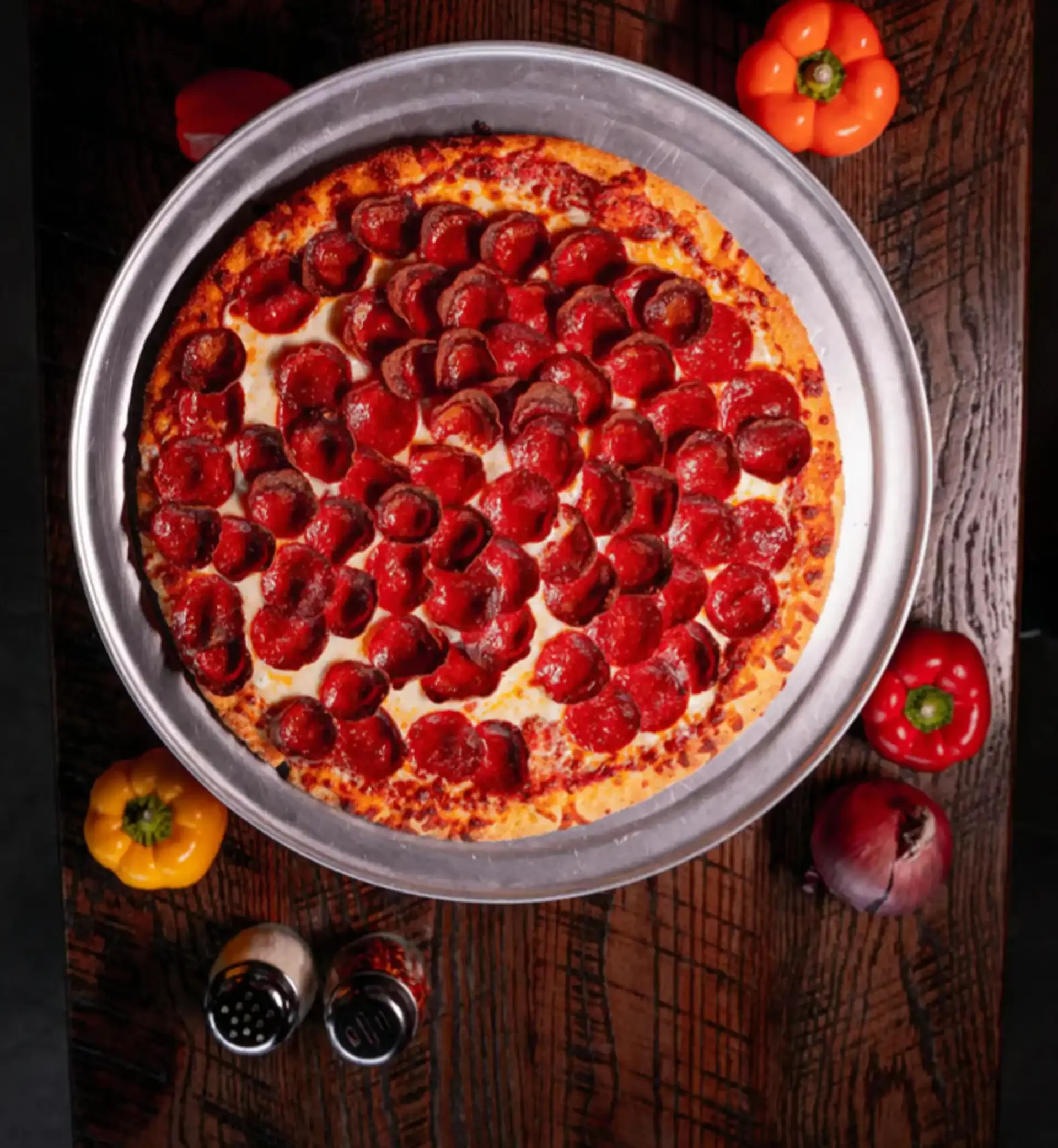 Pepperoni pizza on a rustic wooden table
