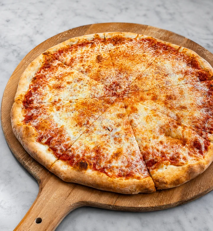 A classic cheese pizza cut into slices, displayed on a wooden pizza paddle.