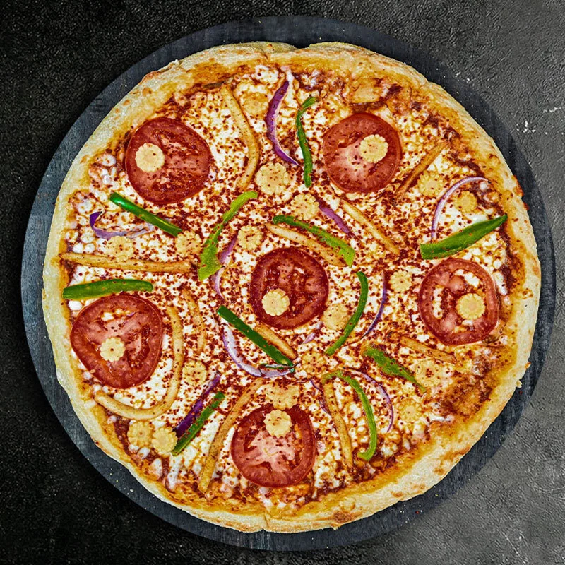 Delicious veggie pizza topped with fresh vegetables and herbs.