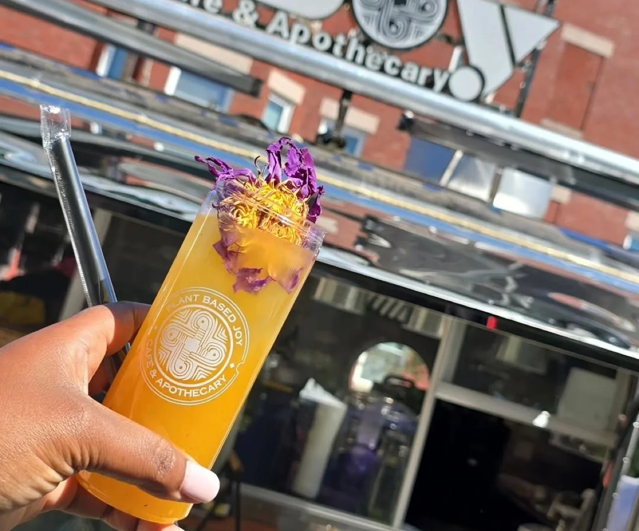 Colorful cocktail with edible flowers at Plant Joy Cafe
