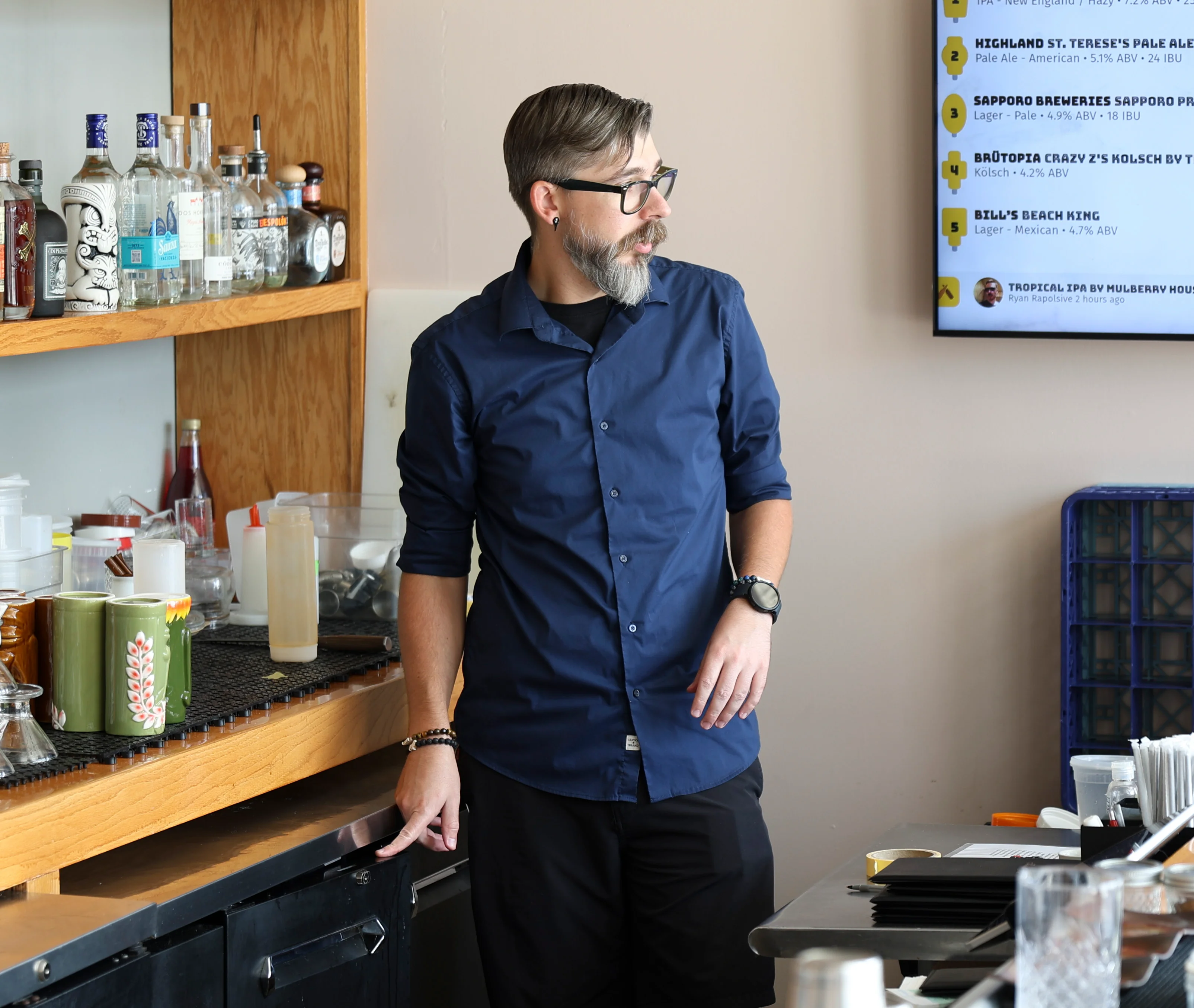 Bartender preparing cocktails at a stylish bar counter