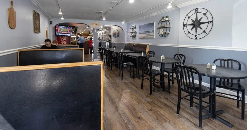 Cozy restaurant interior with wooden tables and nautical decor