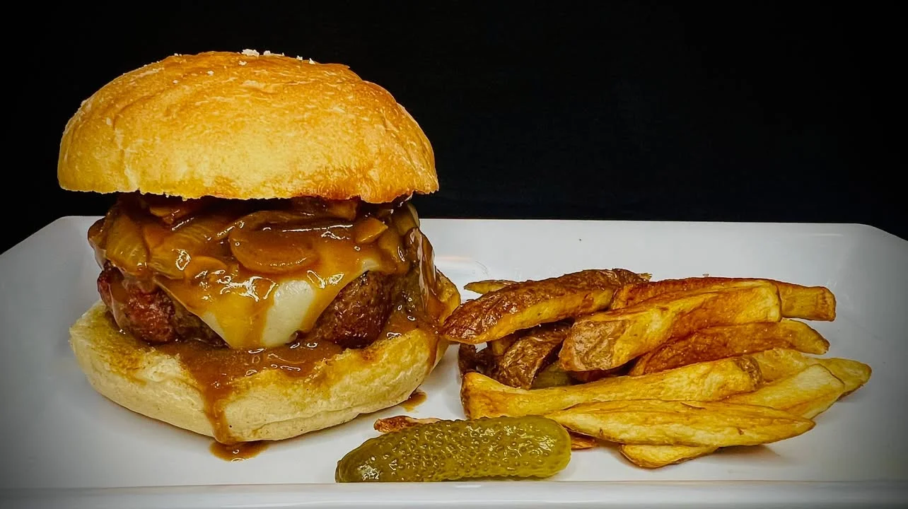 Delicious gourmet burger with fresh toppings on a wooden table