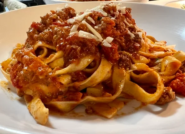 Delicious pasta dish garnished with herbs and cheese