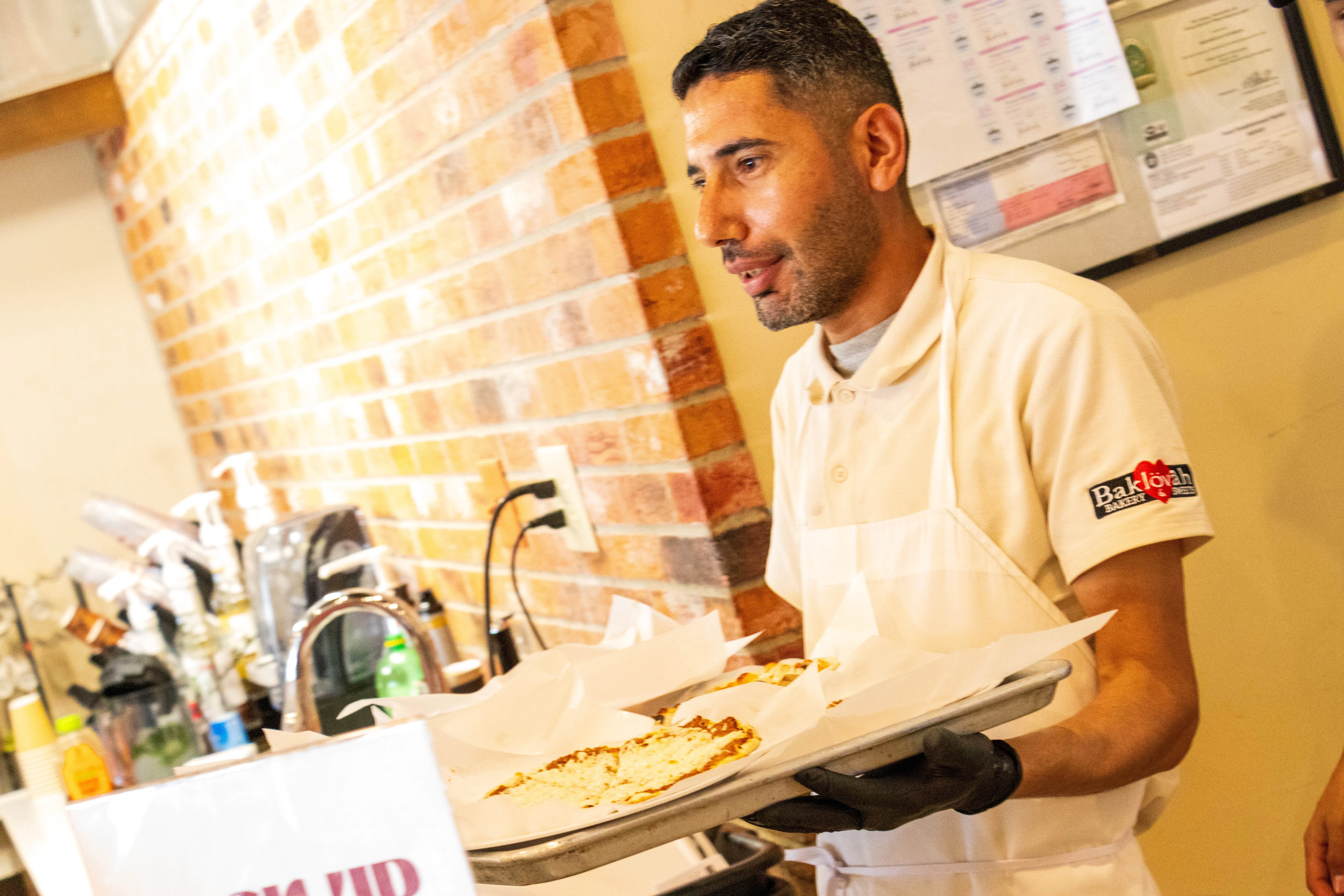 Restaurant staff serving fresh Mediterranean flatbreads