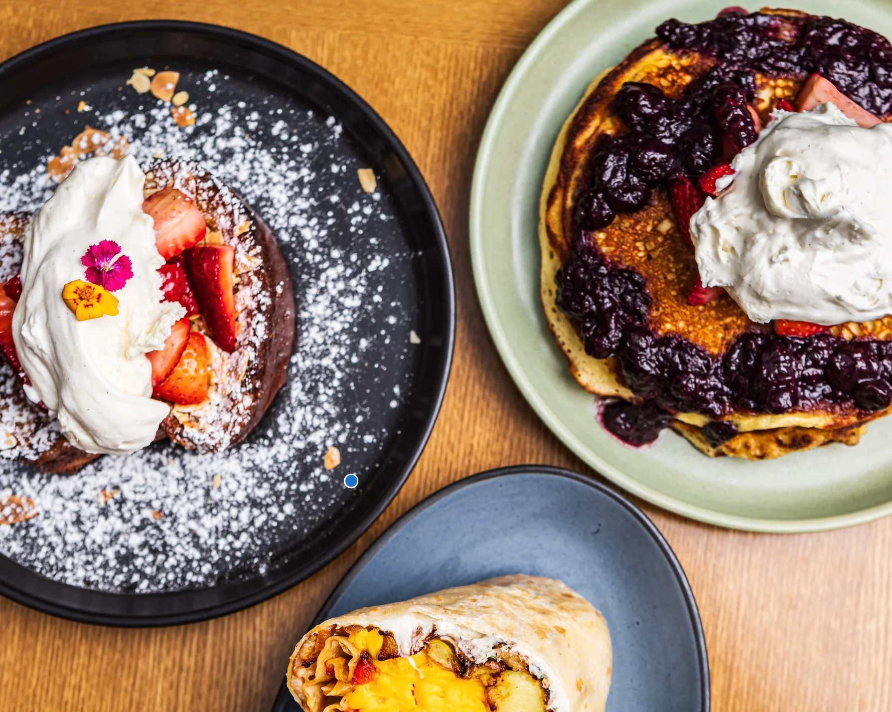 Fluffy pancakes topped with berries and whipped cream