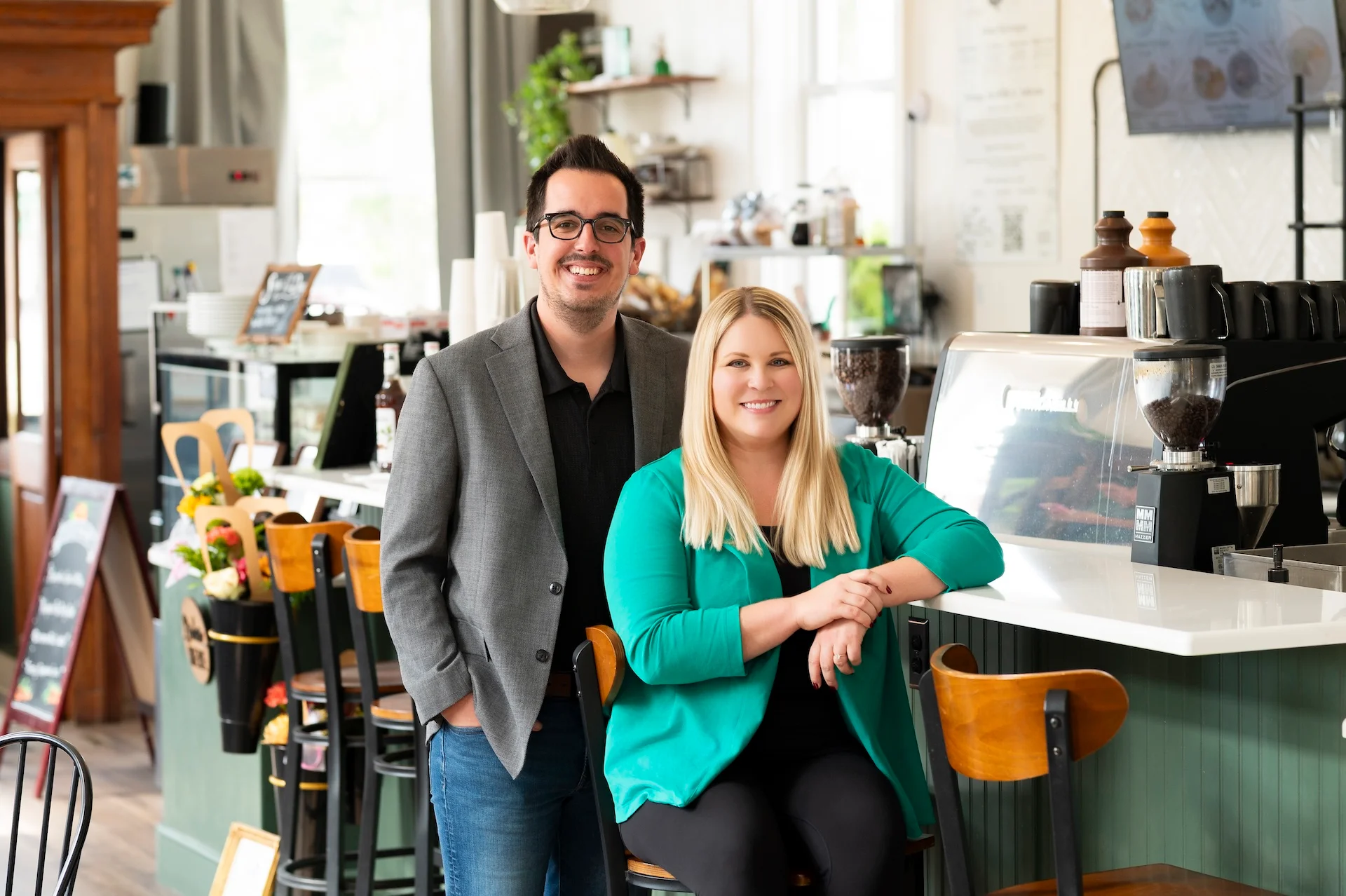 Cozy café interior with smiling owners at the counter