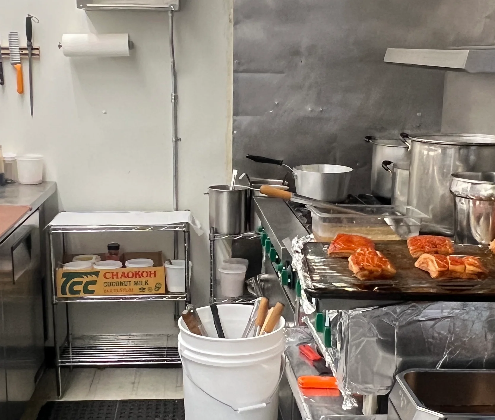 Commercial kitchen with stainless steel equipment and cooking stations