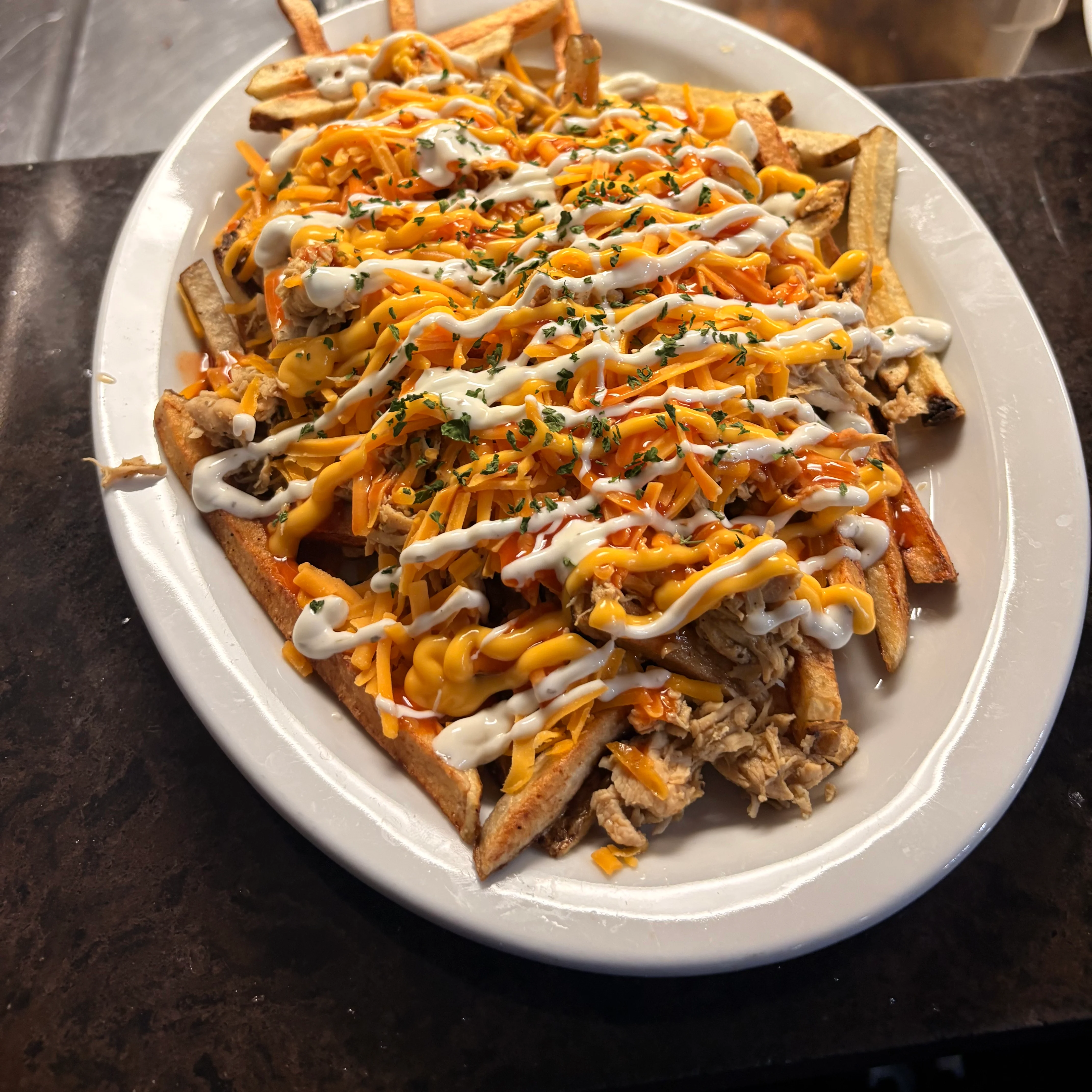 Loaded fries topped with cheese and sauce, a popular comfort food dish