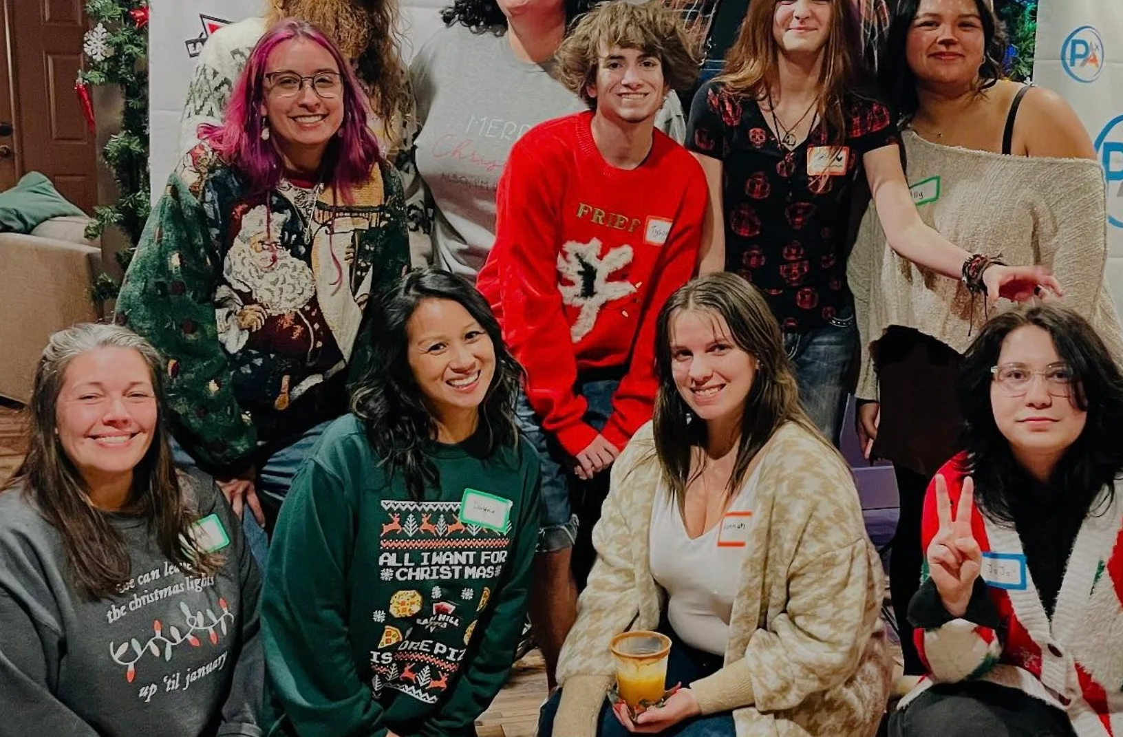 Festive community group photo with Santa hats and shopping carts