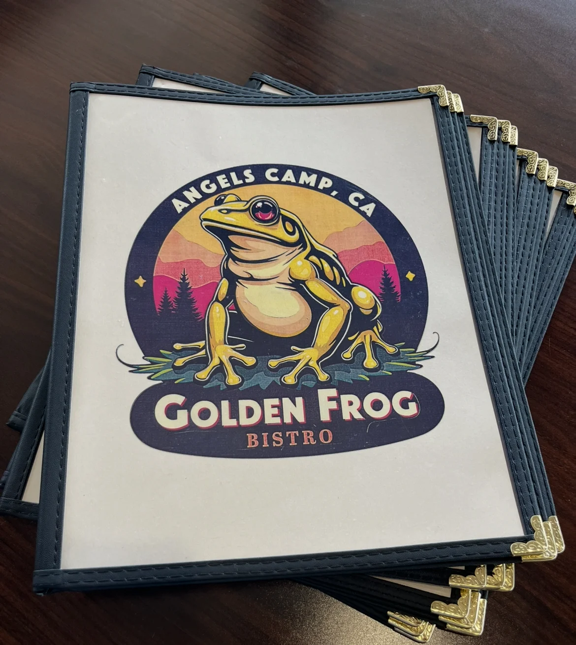 Golden Frog Bistro menu cover featuring a vibrant frog logo