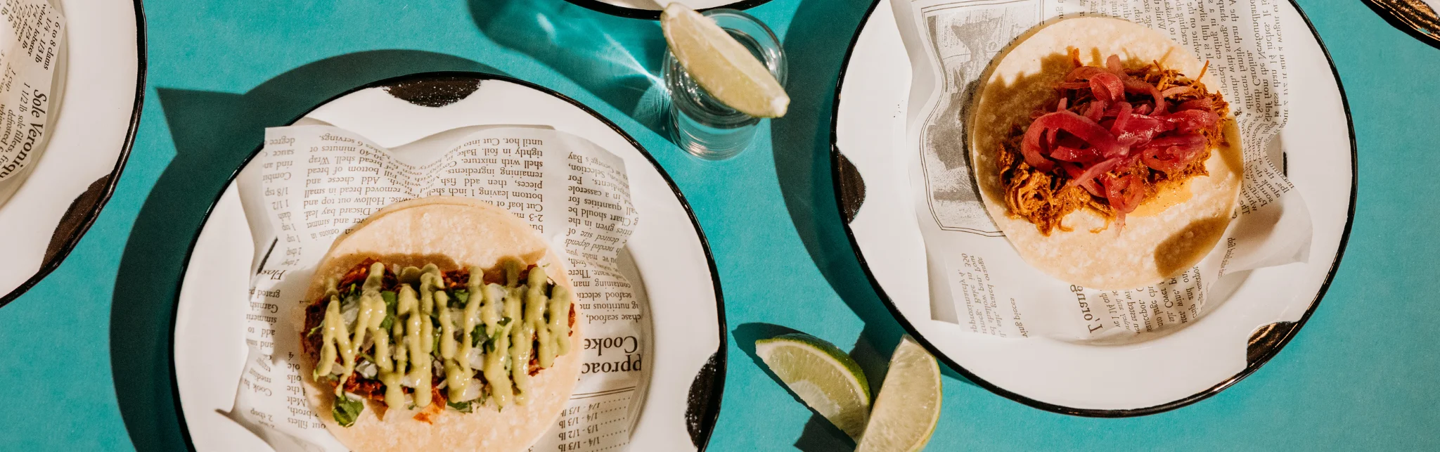 Colorful Mexican tacos with toppings on a vibrant table