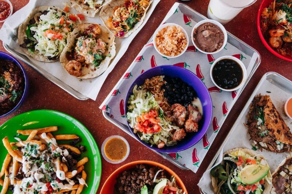 Colorful Mexican taco spread with rice and beans