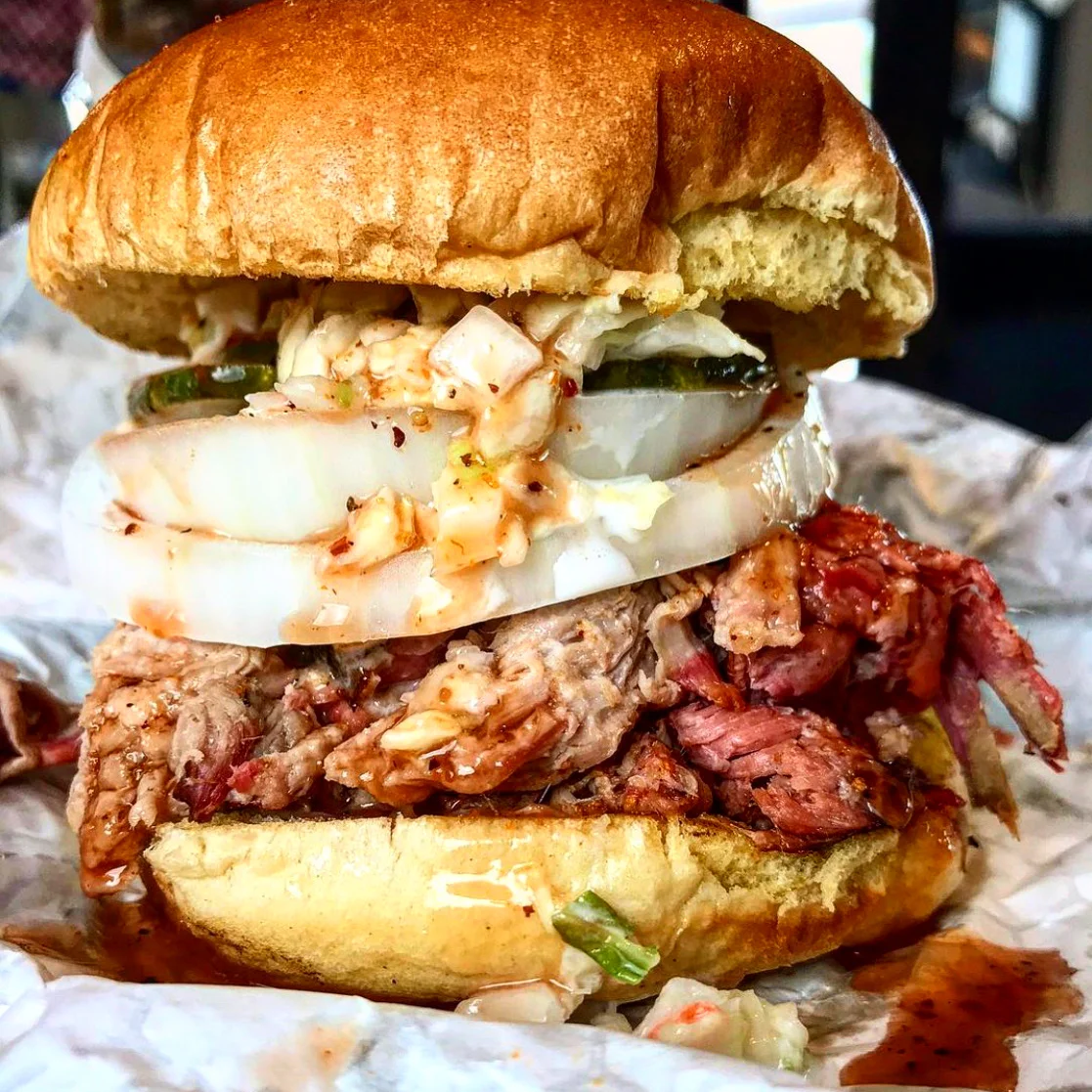 Delicious burger with toppings served on a wooden table