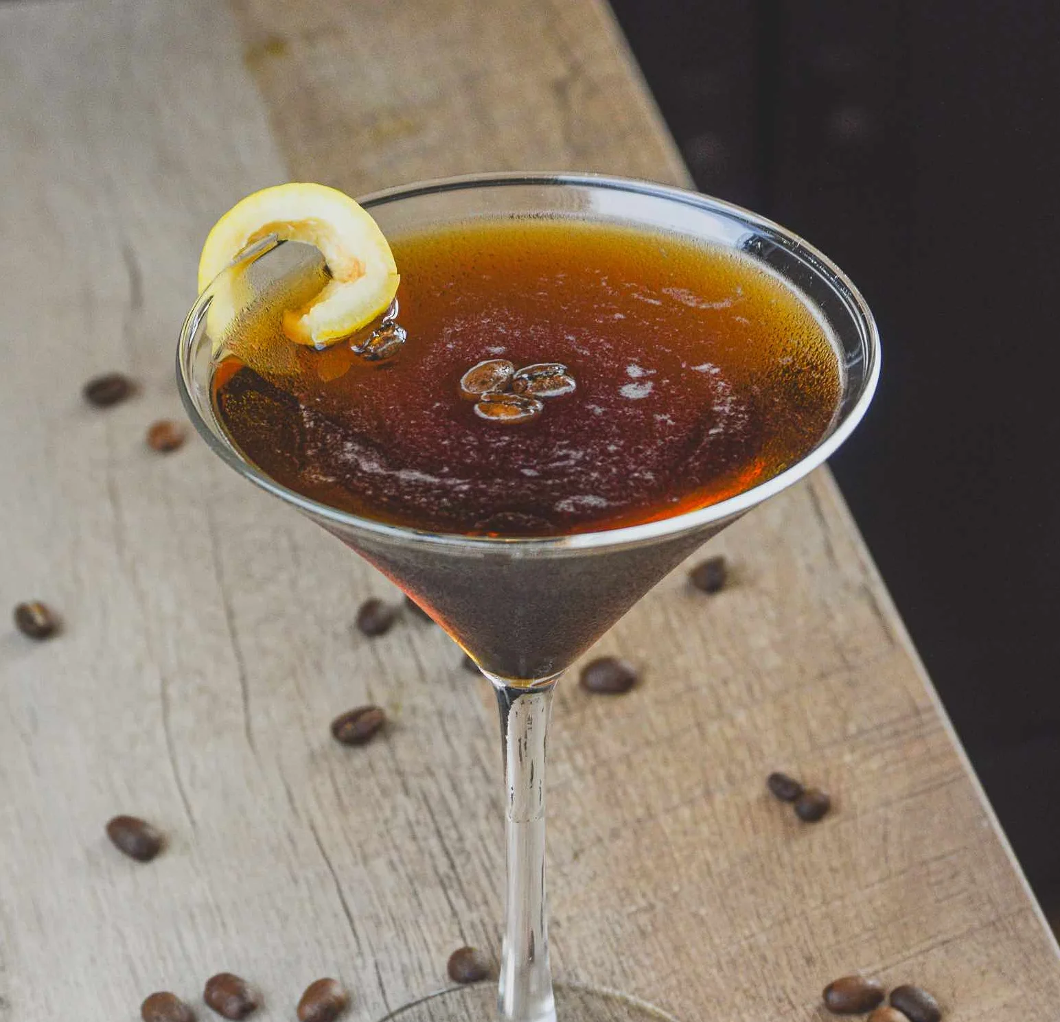 Espress-Yo-Self Martini sitting in the dark surrounded by coffee beans