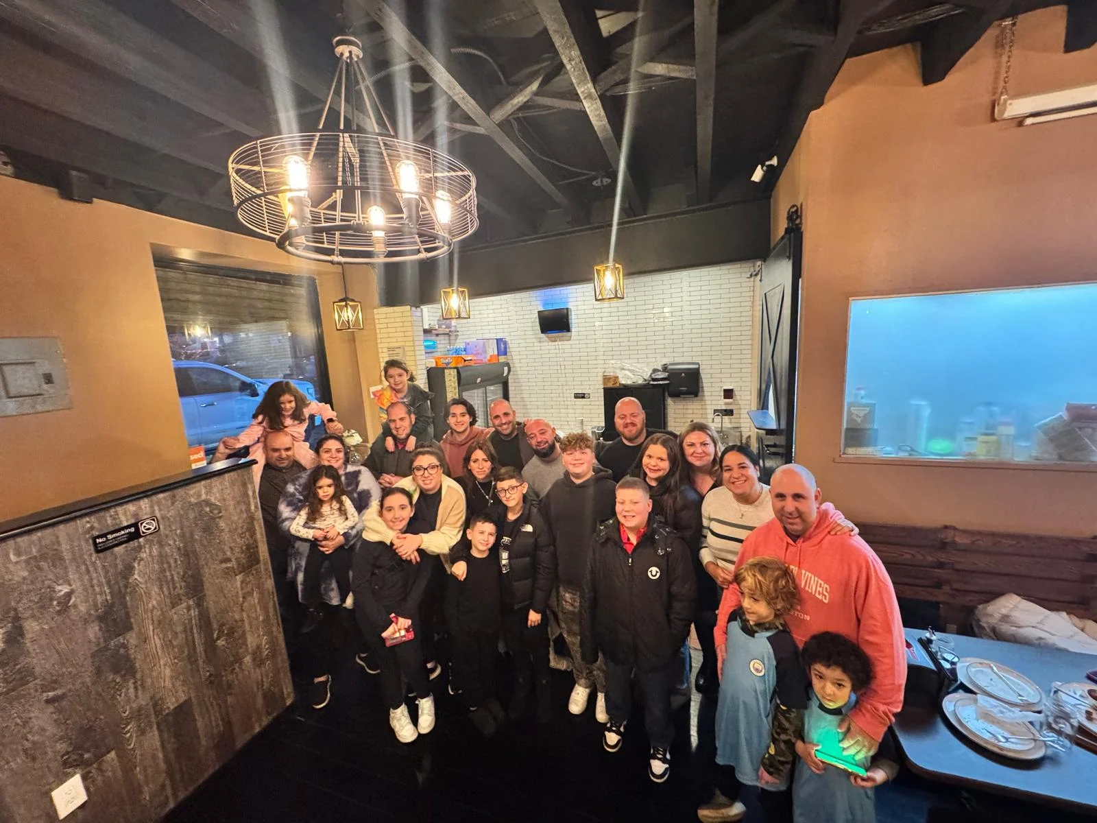 Group photo in a cozy restaurant setting with warm lighting