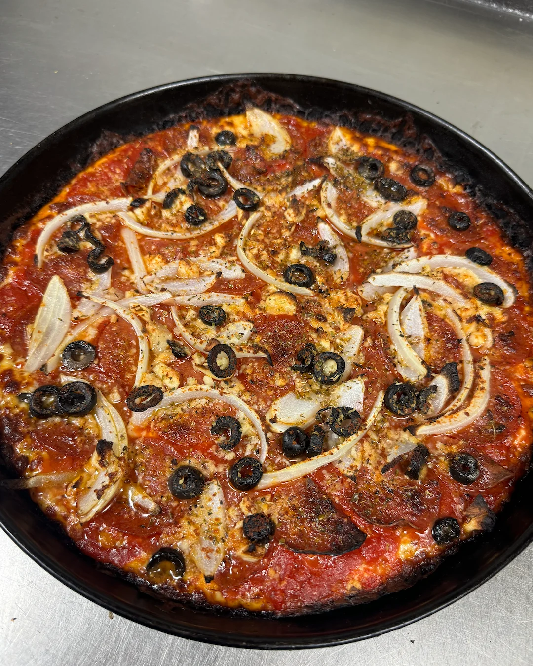Aerial image of pizza with black olive and onion