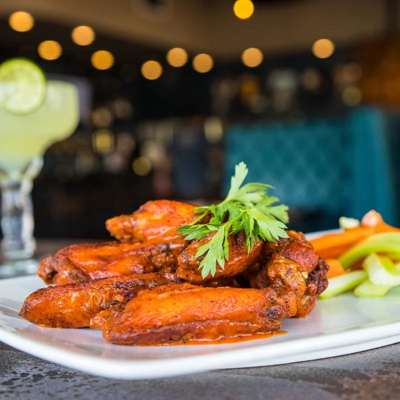 Spicy buffalo chicken wings served with celery and carrots