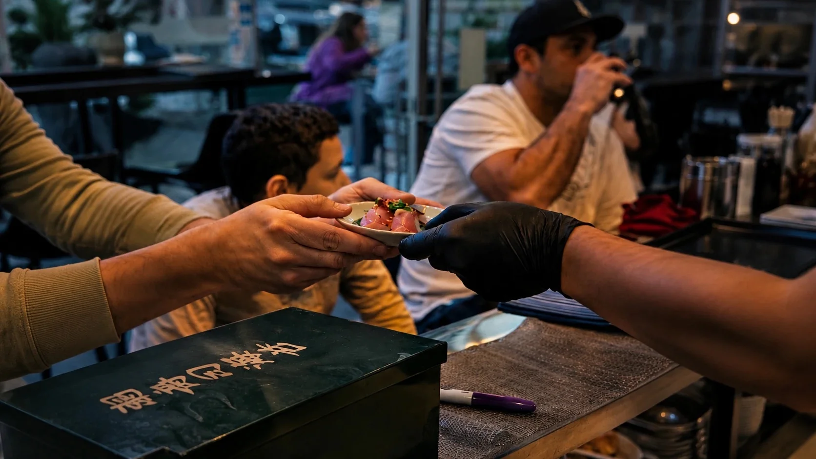 Sushi plate being served in a vibrant restaurant setting