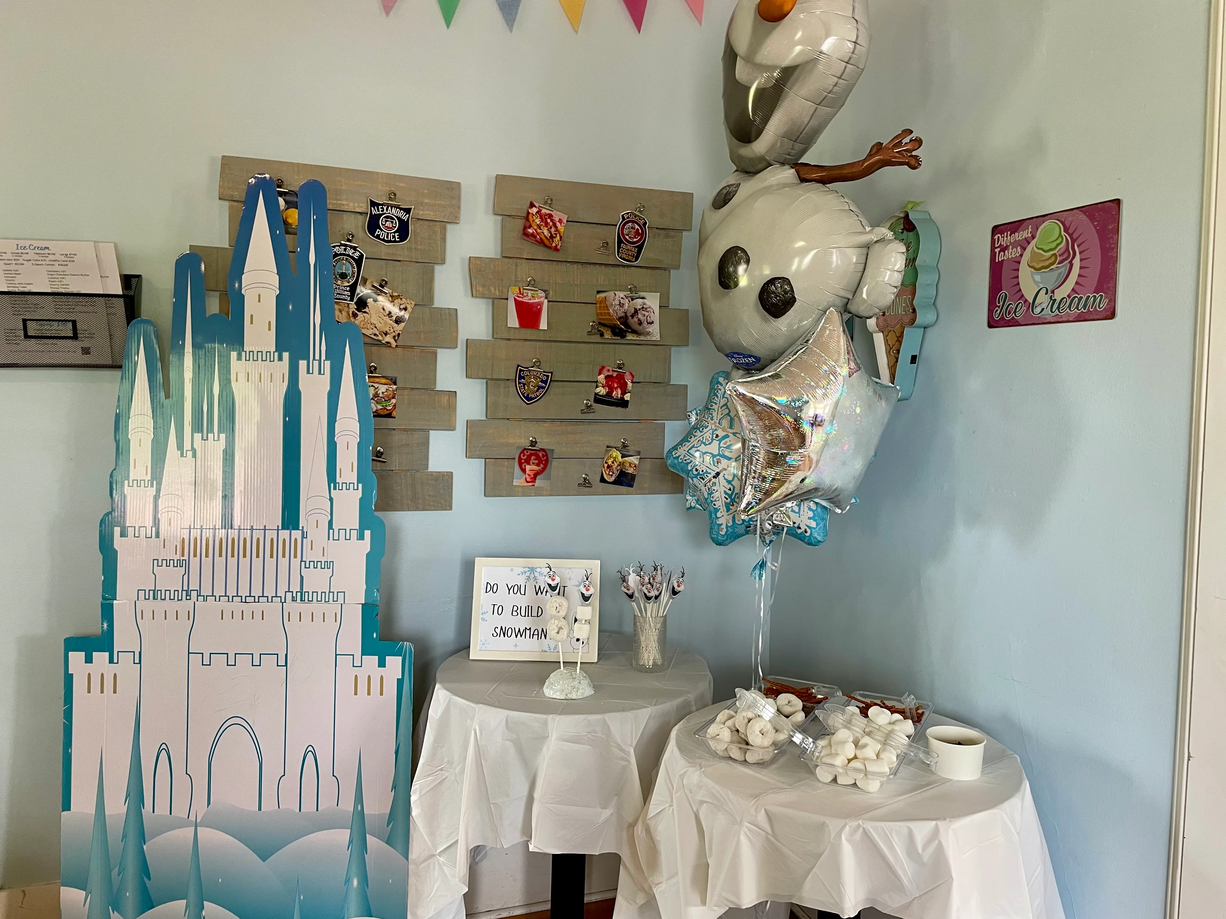 Colorful ice cream shop decor with themed balloons and castle display