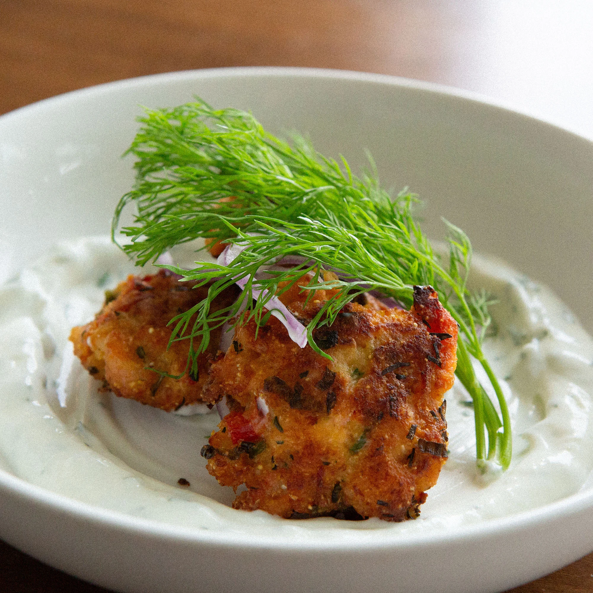 Crispy Indian vegetable fritters with yogurt sauce
