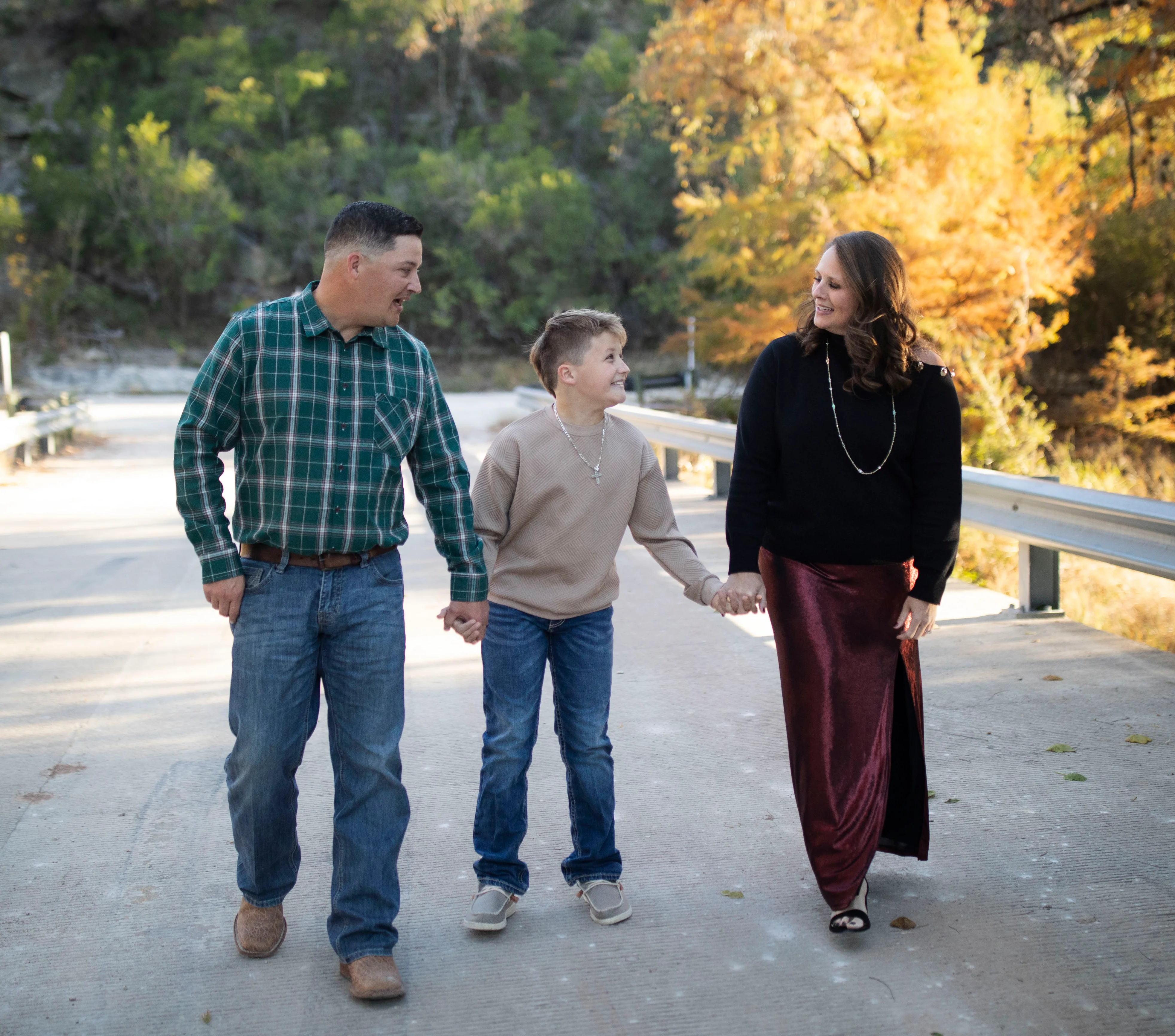 Family walking together on a scenic path in autumn foliage