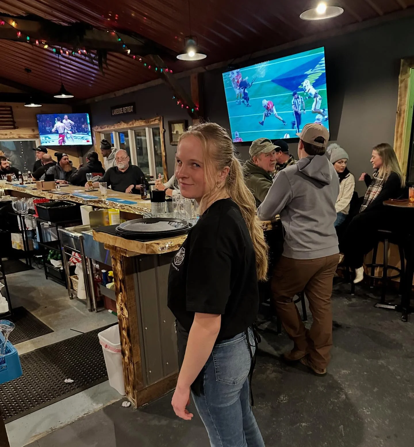 Cozy restaurant interior with patrons enjoying sports on TV